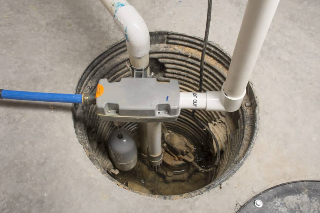 Closeup of residential sump pump in basement