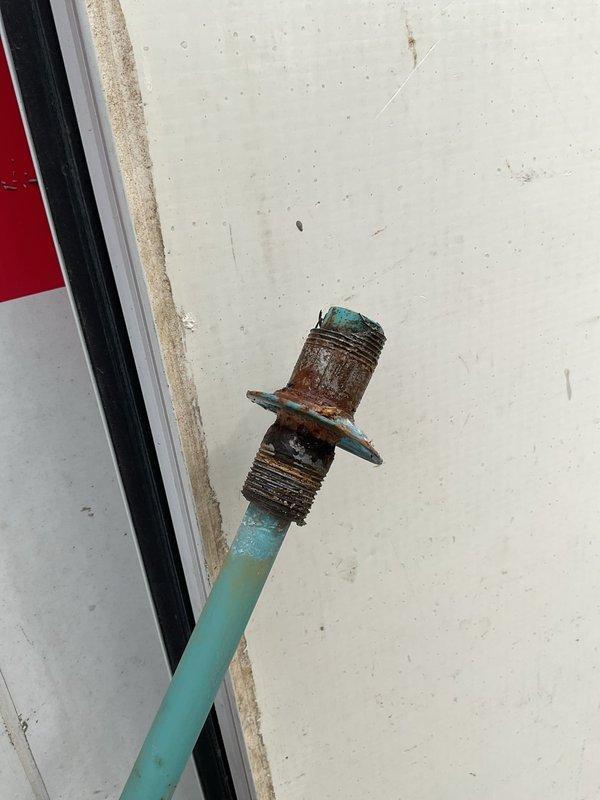 Decatur, IN - Responded to water heater leak investigation at top of tanked unit. Upon inspection, identified heavily corroded threaded nipple fitting exhibiting extensive rust and moisture damage, consistent with active leak condition previously observed during furnace service. Documented corroded plumbing connection with photographic evidence showing deteriorated metal fitting requiring replacement to resolve leak issue.