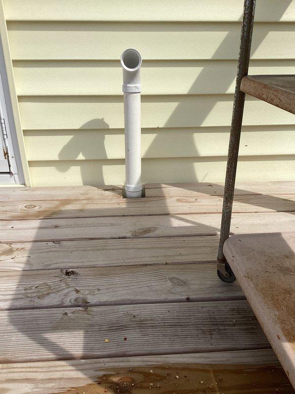 Decatur, IN - Relocated and reinstalled furnace flue piping to accommodate new deck construction. Modified PVC vent pipe routing with proper coupling connections to ensure code-compliant clearances and maintain safe exhaust ventilation for heating system.