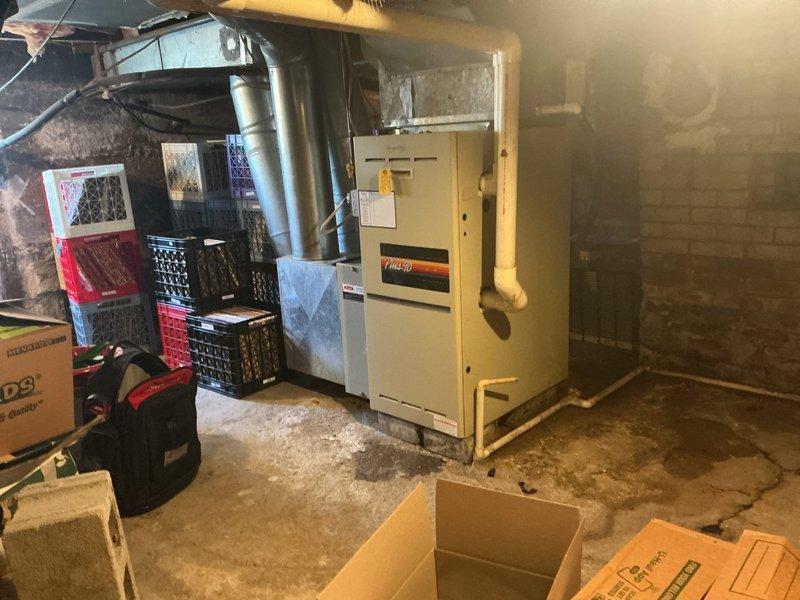 Completed furnace replacement estimate for residential basement installation. Assessed existing furnace unit and ductwork configuration, documented current thermostat setup and HVAC system layout. Provided replacement options for homeowner preparing property for sale.