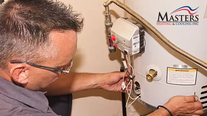 Plumber inspecting water heater