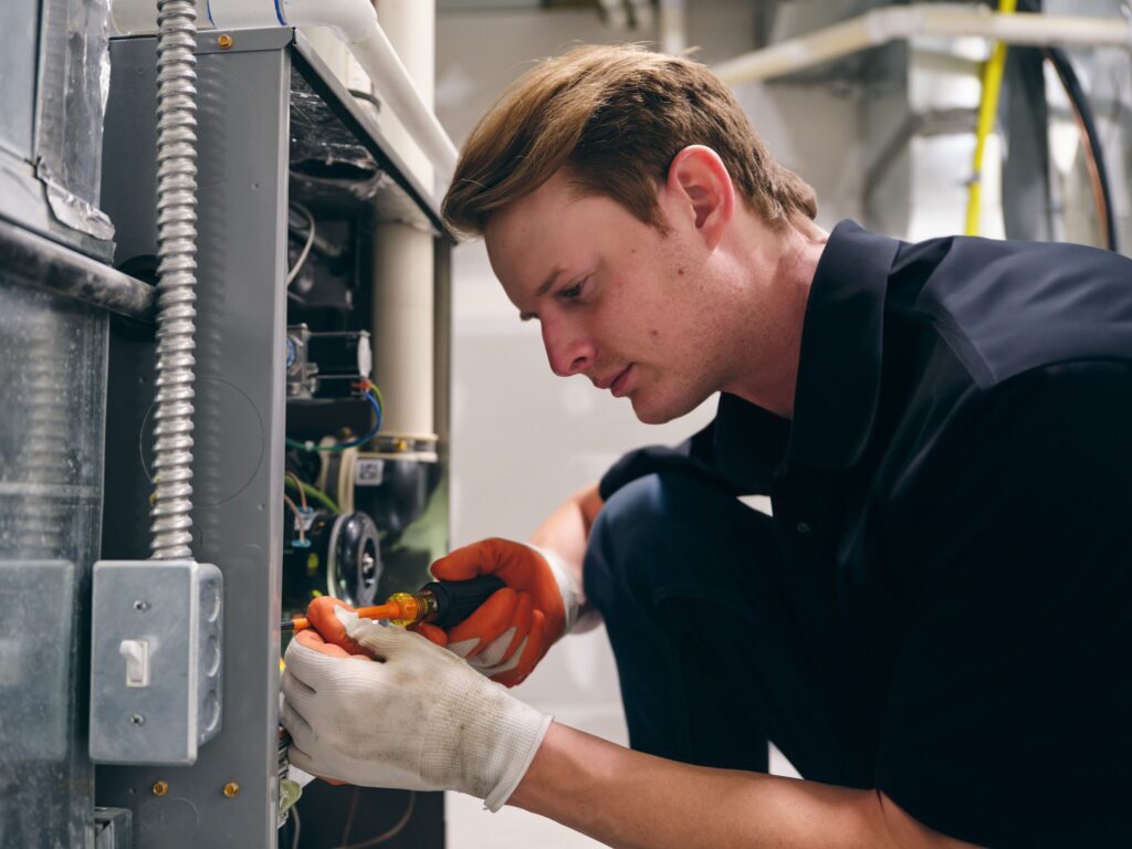 Technician working on residential furnace