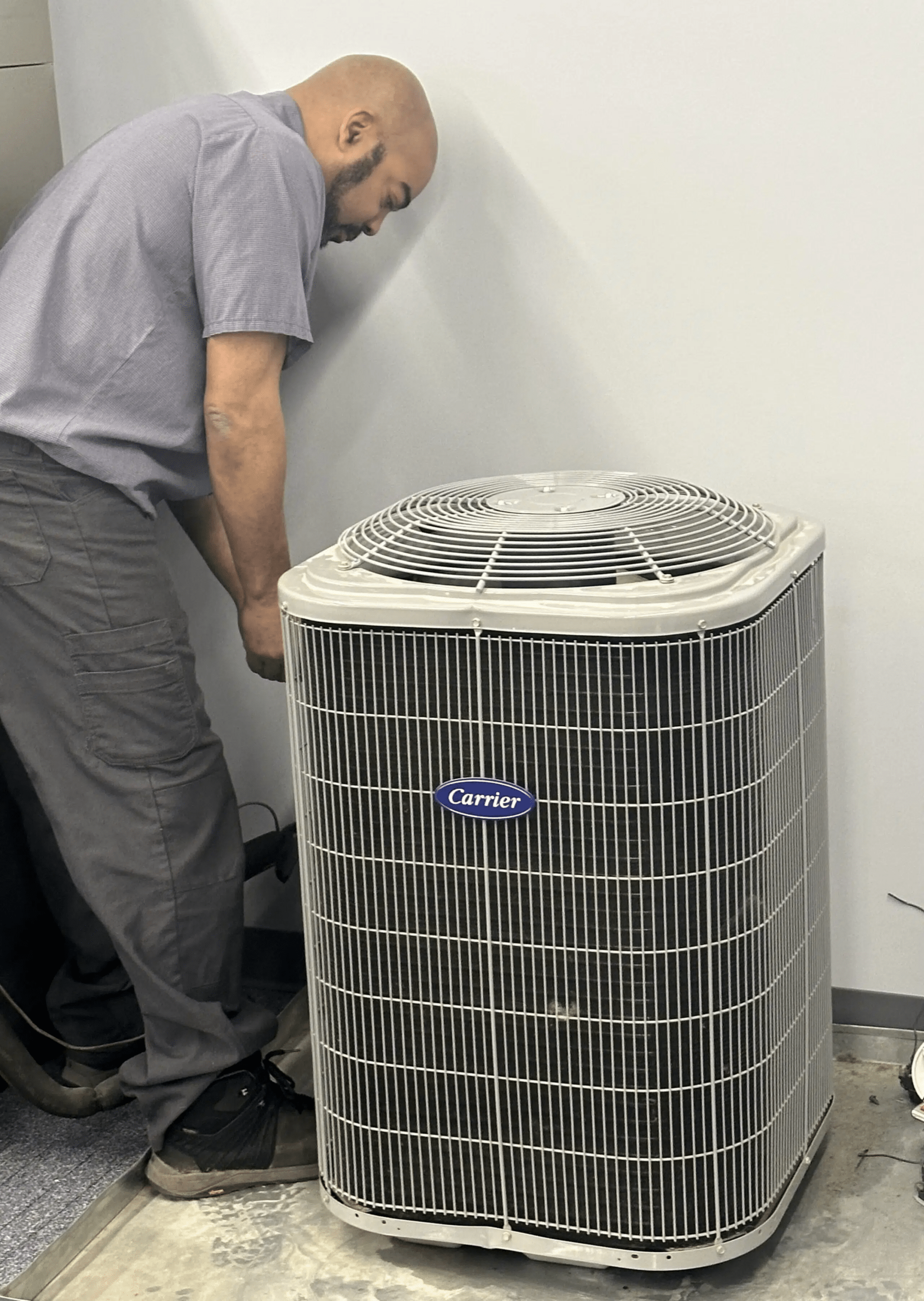HVAC technician working on an outdoor AC unit
