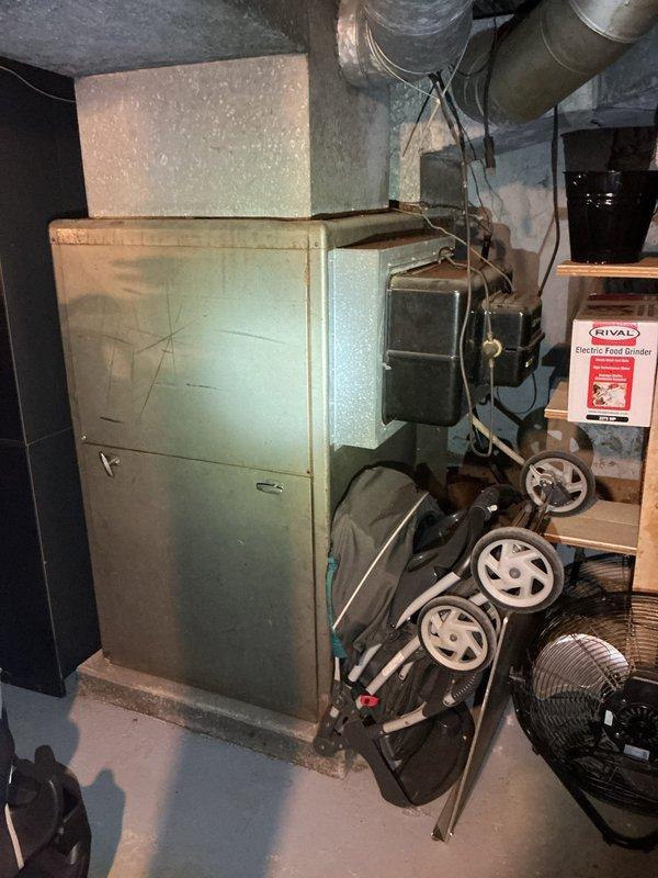 Conducted on-site assessment for complete oil furnace and air conditioning system replacement in basement. Evaluated existing 25+ year-old oil-fired heating equipment and associated ductwork for removal and replacement specifications. Documented current system configuration including furnace dimensions, clearances, and existing duct connections. Assessed fuel oil tank situation and provided guidance regarding fuel removal requirements prior to equipment replacement, clarifying that customer is responsible for arranging fuel oil pump-out service before installation can proceed.