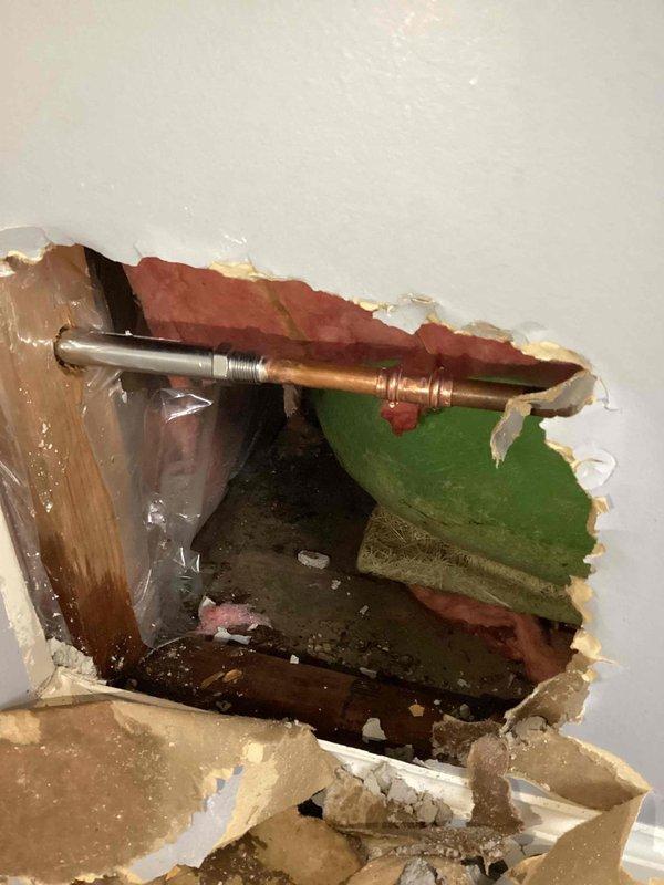 Responded to water leak emergency involving frozen and burst exterior hose bibb and leaking shower valve. Accessed shower plumbing through drywall removal to expose damaged copper supply lines and valve assembly. Replaced compromised piping section with new copper pipe and fittings, installed new shower valve cartridge, and verified proper water flow and shut-off functionality. Replaced frozen exterior faucet with freeze-resistant hose bibb rated for cold climate conditions. Inspected under-sink plumbing connections during service call, confirmed PVC drain assembly and hot/cold supply lines with shut-off valves were secure and functioning properly. Tested all repaired fixtures for leaks, verified proper water pressure, and confirmed no additional moisture damage to surrounding areas.