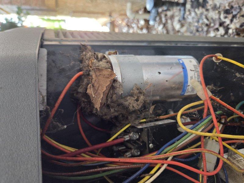 Huntertown, IN - Responded to no cooling call on 10+ year old system with air handler located in attic. Upon inspection, found electrical control panel heavily contaminated with dried mud and debris accumulation on and around the capacitor and internal components. Debris buildup was causing system malfunction and preventing proper operation. Cleaned control box interior, removed all mud and dirt from capacitor and electrical connections, verified all wire terminals were secure, and tested system for proper operation. Unit restored to normal cooling function.
