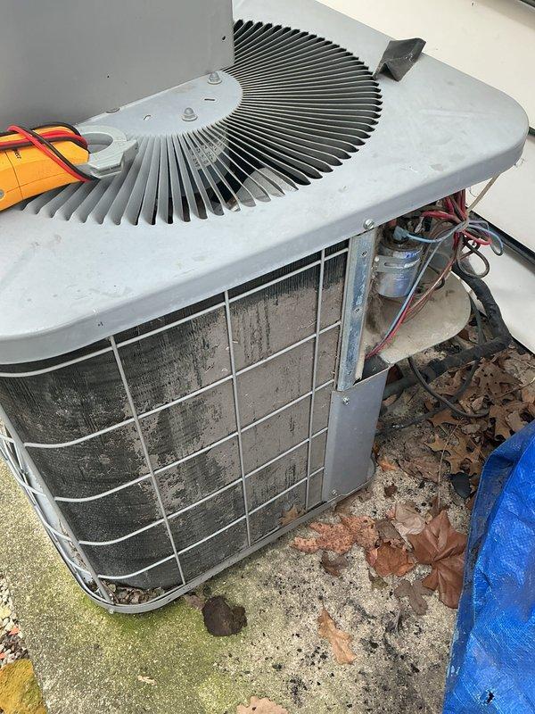 Responded to no cooling complaint on Unit 4. Upon inspection, found outdoor condenser unit with severely contaminated coil fins showing heavy dirt, debris, and grime accumulation restricting airflow. Return air filter system exhibited excessive dust buildup with thick gray coating obscuring filter material, significantly reducing system airflow and efficiency. Cleaned condenser coils, replaced dirty air filter, and restored unit to proper cooling operation. System tested and confirmed operational following maintenance.
