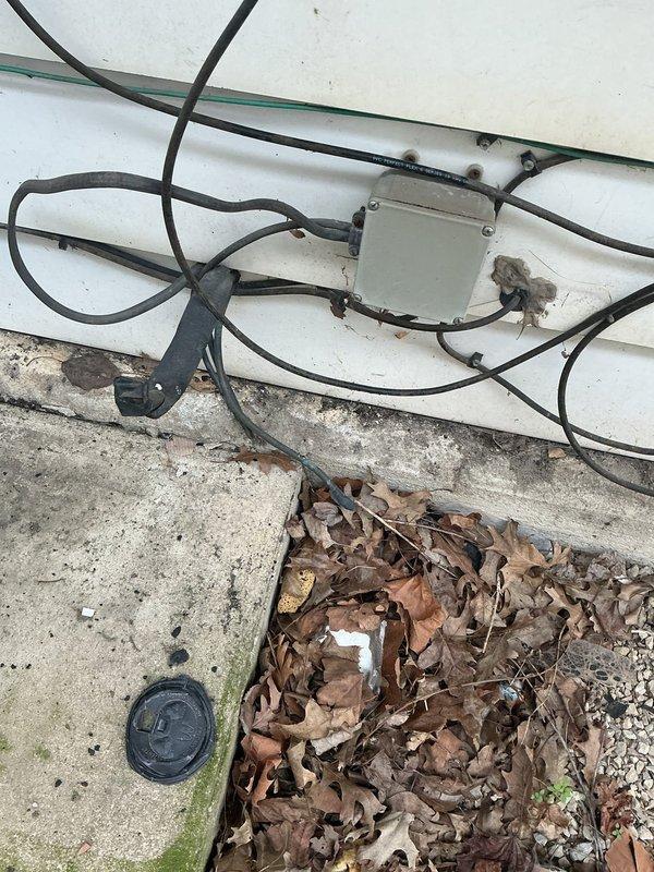 Berne, IN - Responded to no cool complaint on Unit 6. Upon arrival, inspected exterior equipment and electrical connections at building exterior. Photos documented existing conditions including electrical junction box, wiring runs, and surrounding area for service records.