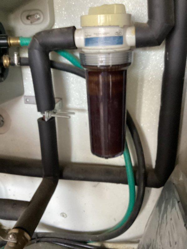Provided estimate for replacement of existing water softener unit, which is over 15 years old and no longer functioning effectively. Assessed current system located in garage, including existing water filtration components with translucent filter housing and connecting plumbing infrastructure. Documented equipment condition and photographed installation area to prepare comprehensive replacement proposal for new water treatment system.