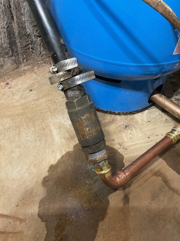 Monroeville, IN - Performed initial assessment and installation work for whole house water treatment system. Connected plumbing components including blue storage tank with black discharge hose secured by metal clamps to copper supply line with compression fittings. Identified need for 3/4" inline whole house filter, which has been ordered and requires scheduling for completion of installation.