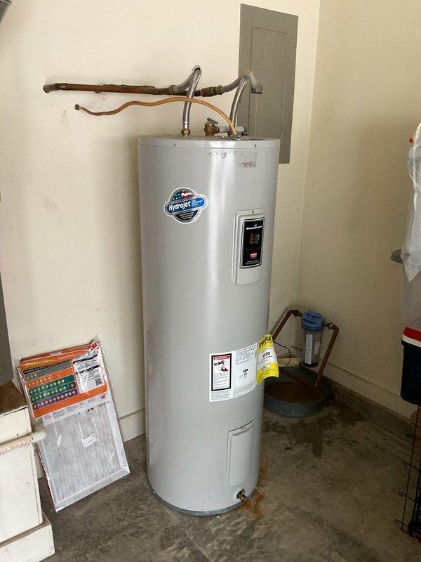 Decatur, IN - Responded to service call for tanked water heater with suspected failing heating element. Upon arrival, inspected InSinkErator brand electric water heater unit located in garage utility area. Evaluated heating element performance, tested electrical connections at digital control panel, and assessed overall system operation including copper supply and discharge piping connections. Discussed OmniFilter water filtration system maintenance needs with customer as requested. Documented equipment condition and configuration with photographs for service records.