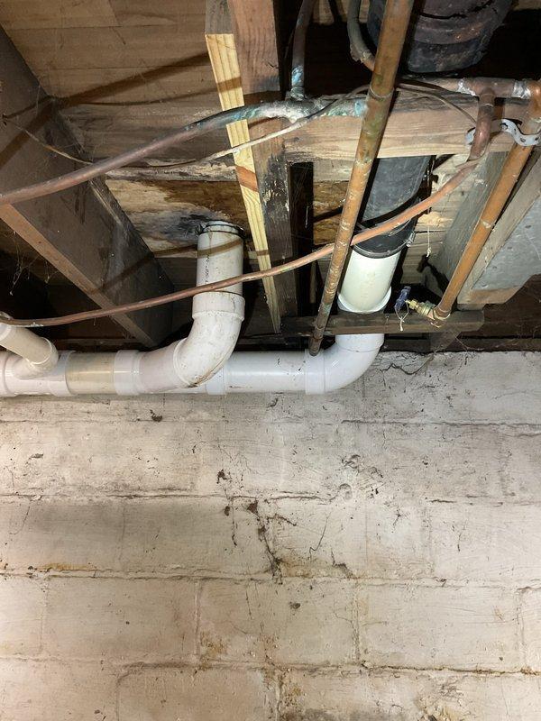 Responded to report of water audible within walls on lower level of residence. Conducted thorough inspection of basement/crawlspace area and identified source of water intrusion affecting downstairs area. Inspected exposed plumbing infrastructure including PVC drainage system, copper supply lines, and floor joist cavities. Assessed structural components and plumbing connections for leaks or failures. Documented conditions of affected areas including bathroom fixtures and foundation walls showing no visible discoloration despite audible water presence. Completed diagnostic evaluation and photographic documentation of plumbing systems and potential leak sources for repair recommendations.