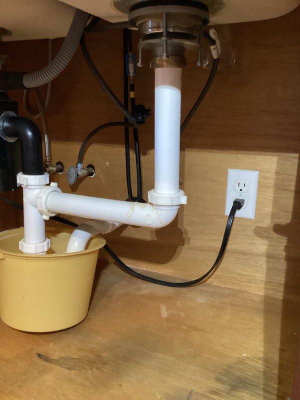Replaced kitchen faucet with homeowner-provided brushed nickel pull-down model featuring high-arc spout design. Installed new faucet assembly on stainless steel double-basin sink with dark green tile countertop, ensuring proper mounting and connection to existing water supply lines and drain configuration.