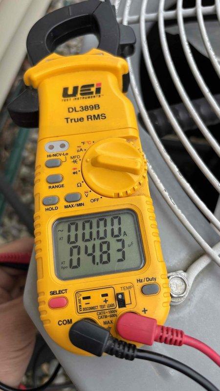 Completed first prepaid cooling maintenance visit on residential HVAC system. Performed comprehensive system diagnostics using digital clamp meter to verify electrical readings and amperage draw. Inspected motor run capacitor rated at 440V with 10,000 microfarad capacitance, confirmed proper operation and secure electrical connections across all wire terminals including yellow, blue, brown, and black conductors. Condenser coil inspected and found to be in clean condition with no debris obstruction. All system components operating within normal parameters.