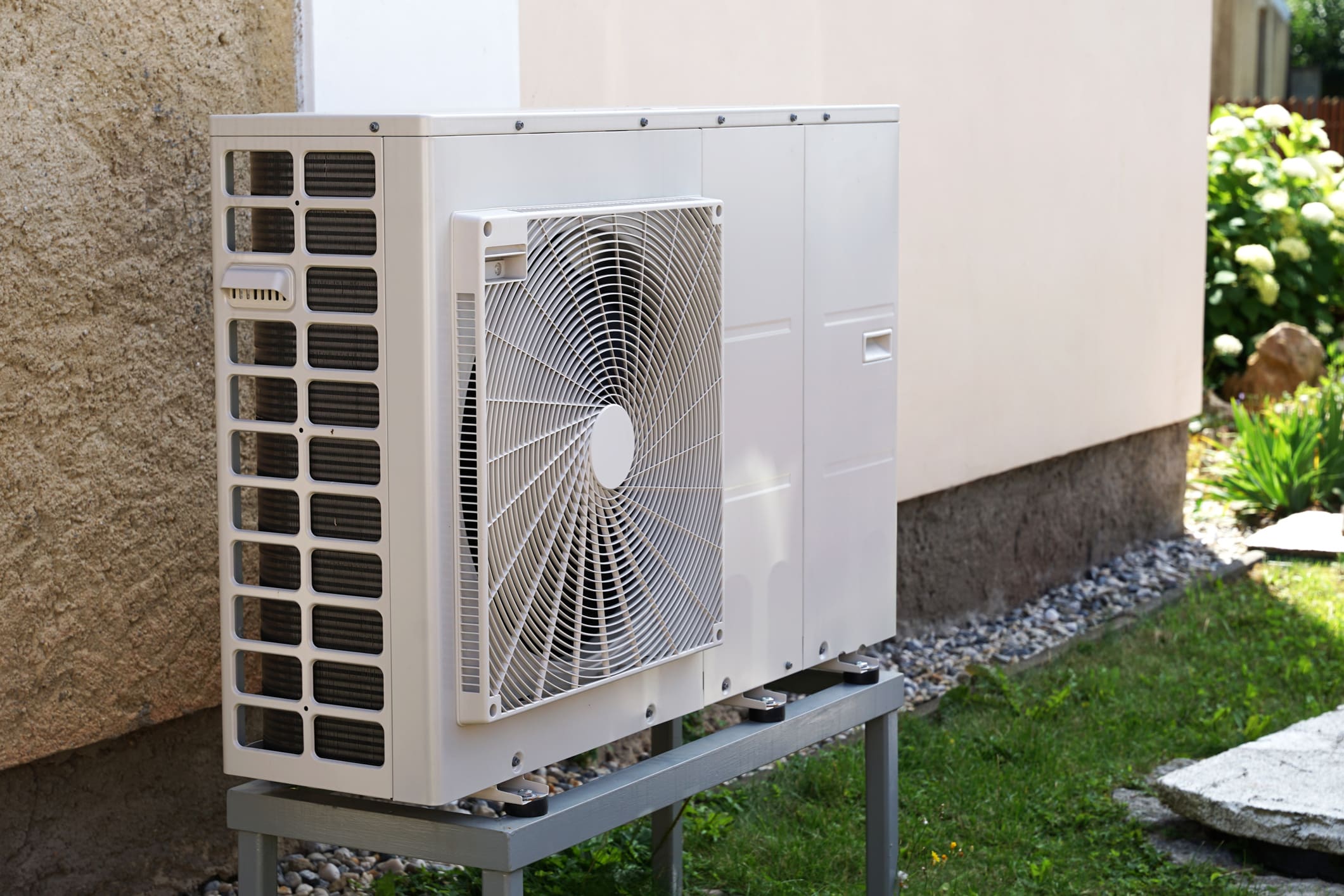 Heat pump mounted on the wall of an Indiana home