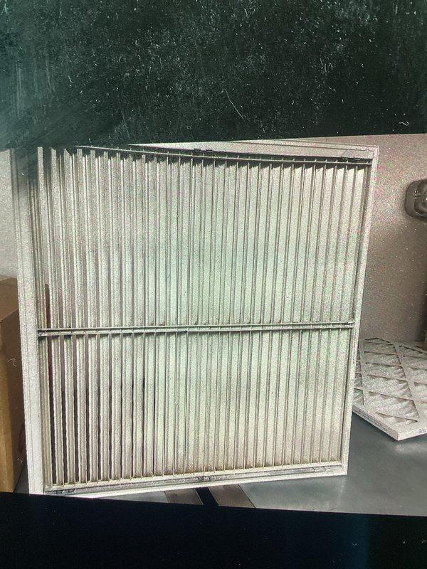 Responded to no cooling complaint at commercial shop with indoor temperature at 80°F. Upon arrival, found system had been shut off by customer after they attempted filter change, which resulted in supply grille and condensate drain line becoming disconnected. Inspected ceiling-mounted air handler, reinstalled dirty pleated filter properly, secured supply air grille back into drop ceiling grid, and reconnected condensate drain tubing to prevent water damage. Instructed customer on proper filter replacement procedure to avoid future issues, started system, and verified unit now operating correctly with cool air delivery restored.