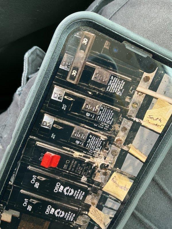 Decatur, IN - Responded to emergency service call for power outage in basement/mechanical area caused by burst plumbing pipe and water intrusion. Upon arrival, found electrical panel exposed to water damage with visible corrosion and deterioration on breakers, bus bars, and internal components. Identified tripped breakers and water-damaged circuits as source of power loss. De-energized main breaker and documented extensive corrosion throughout panel assembly, including rust on mounting hardware and connection points. Assessed panel condition and determined immediate safety hazard due to water exposure and compromised electrical components. Recommended complete panel replacement and coordination with plumbing contractor to address water source before restoration of electrical service.