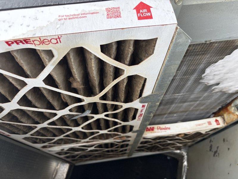 # HVAC Service - No Cool 10+ Years Old

Responded to service call for downstairs unit not cooling. Upon arrival, performed system inspection to diagnose cooling failure. Found heavily contaminated evaporator coil with significant accumulation of dust, dirt, and debris throughout the fin structure. The buildup was restricting proper airflow across the coil, severely impacting heat transfer efficiency and cooling capacity.

Inspected air filtration system and discovered dirty pleated air filter in return air plenum. The filter media showed substantial particulate loading, indicating extended service interval and contributing to reduced system airflow and coil contamination. Restricted airflow from the clogged filter was a primary factor in the no-cooling condition.

Recommended thorough coil cleaning to restore proper heat transfer and system efficiency. Advised replacement of air filter with appropriate MERV-rated filter and discussed importance of regular filter maintenance schedule to