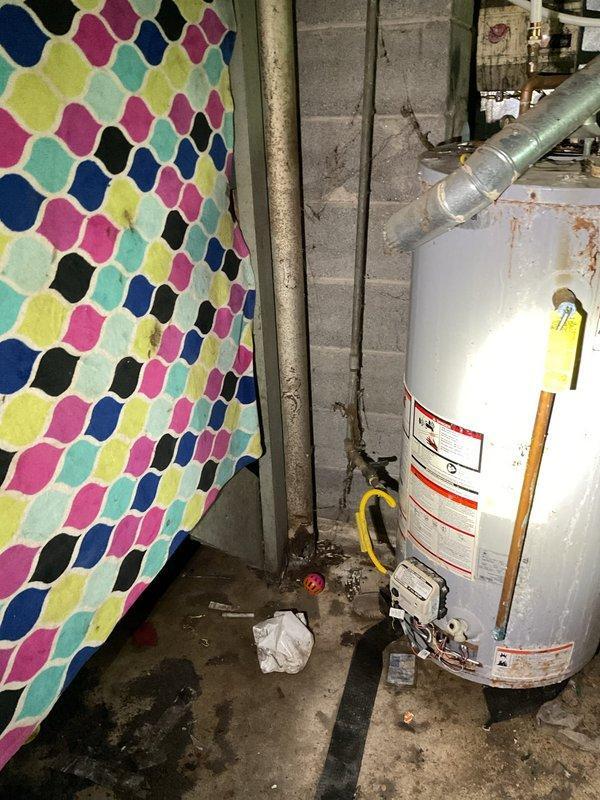 Provided estimate for replacement of existing gas-fired tank-type water heater located in basement. Unit assessed with visible aging, moisture staining on floor beneath unit, and standard venting configuration through existing galvanized ductwork. Scope includes removal and disposal of old water heater, installation of new gas tank water heater utilizing existing gas line connections and plumbing infrastructure, and verification of proper venting and code compliance.